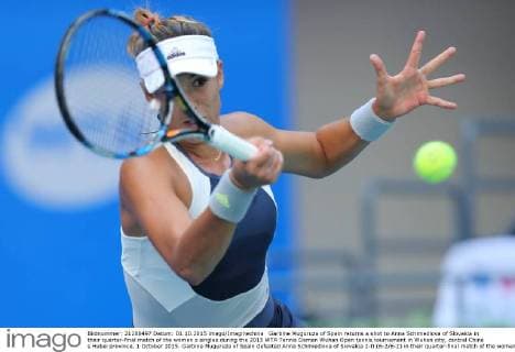 Garbine Muguruza of Spain returns a shot to Anna Schmiedlova of Slovakia in their quarter-final match of the women s singles during the 2015 WTA Tennis Damen Wuhan Open tennis tournament in Wuhan city, central China s Hubei province, 1 October 2015. Garbine Muguruza of Spain defeated Anna Schmiedlova of Slovakia 2-0 (6-2 6-2) in their quarter-final match of the women s singles during the 2015 WTA Wuhan Open tennis tournament in Wuhan city, central China s Hubei province, on Thursday (1 October 2015). Garbine Muguruza beats Anna Schmiedlova to advance at Wuhan Open  pbu339423_02