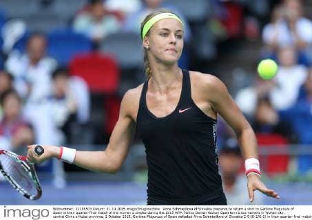 Anna Schmiedlova of Slovakia prepares to return a shot to Garbine Muguruza of Spain in their quarter-final match of the women s singles during the 2015 WTA Tennis Damen Wuhan Open tennis tournament in Wuhan city, central China s Hubei province, 1 October 2015. Garbine Muguruza of Spain defeated Anna Schmiedlova of Slovakia 2-0 (6-2 6-2) in their quarter-final match of the women s singles during the 2015 WTA Wuhan Open tennis tournament in Wuhan city, central China s Hubei province, on Thursday (1 October 2015). Garbine Muguruza beats Anna Schmiedlova to advance at Wuhan Open  pbu339423_09