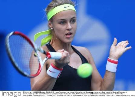 Anna Schmiedlova of Slovakia prepares to return a shot to Garbine Muguruza of Spain in their quarter-final match of the women s singles during the 2015 WTA Tennis Damen Wuhan Open tennis tournament in Wuhan city, central China s Hubei province, 1 October 2015. Garbine Muguruza of Spain defeated Anna Schmiedlova of Slovakia 2-0 (6-2 6-2) in their quarter-final match of the women s singles during the 2015 WTA Wuhan Open tennis tournament in Wuhan city, central China s Hubei province, on Thursday (1 October 2015). Garbine Muguruza beats Anna Schmiedlova to advance at Wuhan Open  pbu339424_03