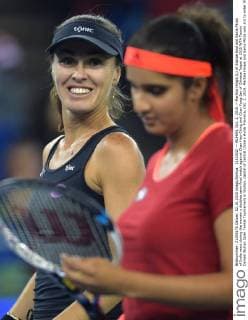 (151002) -- WUHAN, Oct. 2, 2015 -- Martina Hingis (L) of Switzerland and Sania Mirza of India react during the women s doubles semi-final match against Chan Hao-Ching and Chan Yung-Jan of Chinese Taipei at 2015 WTA Tennis Damen Wuhan Open Tennis Tournament in Wuhan, capital of central China s Hubei Province, Oct. 2, 2015. Martina Hingis and Sania Mirza won 2-0 to enter the final. ) (SP)CHINA-WUHAN-TENNIS-WTA-WUHAN OPEN (CN) ChengxMin 