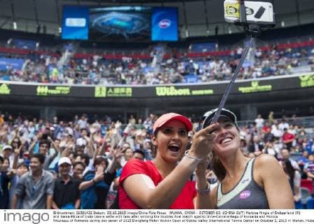 WUHAN, CHINA - OCTOBER 03: (CHINA OUT) Martina Hingis of Switzerland (R) and Sania Mirza of India take a selfie with fans after winning the doubles final match against Irina-Camelia Begu of Romania and Monica Niculescu of Romania during day seven of 2015 Dongfeng Motor Wuhan Open at Optics Valley International Tennis Center on October 3, 2015 in Wuhan, Hubei Province of China.  CFP473797587 