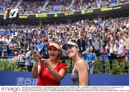 WUHAN, CHINA - OCTOBER 03: (CHINA OUT) Martina Hingis of Switzerland (R) and Sania Mirza of India take a selfie with fans after winning the doubles final match against Irina-Camelia Begu of Romania and Monica Niculescu of Romania during day seven of 2015 Dongfeng Motor Wuhan Open at Optics Valley International Tennis Center on October 3, 2015 in Wuhan, Hubei Province of China.  CFP473797585 