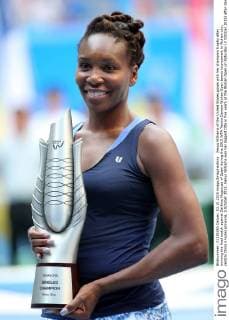 Venus Williams of the United States poses with her champion trophy after winning the final match against Garbine Muguruza of Spain during the 2015 WTA Tennis Damen Wuhan Open tennis tournament in Wuhan city, central China s Hubei province, 3 October 2015. Venus Williams won her biggest title in five years at the Wuhan Open on Saturday (3 October 2015) after Garbine Muguruza quitted, making her the fifth player to pull out mid-match in the late-season tournament. Williams took the first set and was three games up in the second when the Spaniard stopped play at 53 minutes, handing the American veteran the 47th title win of her career, and her first victory at a WTA Premier Five event since she beat Victoria Azarenka in 2010 in Dubai. Wimbledon finalist Muguruza, ranked world number eight, 16 places ahead of American veteran Williams, had a tough semi-final against Germany s Angelique Kerber, winning in straight sets but falling during the closing tie break and injuring her ankle. But the 21-year-old said it was exhaustion not injury that made her pull out. Venus wins 47th career title as Muguruza quits Wuhan Open final  20151003_09365