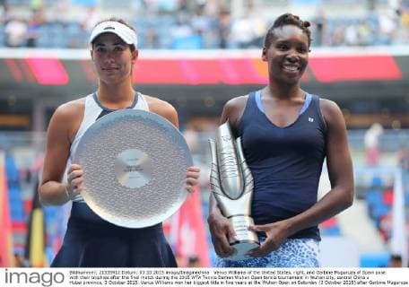 Venus Williams of the United States, right, and Garbine Muguruza of Spain pose with their trophies after the final match during the 2015 WTA Tennis Damen Wuhan Open tennis tournament in Wuhan city, central China s Hubei province, 3 October 2015. Venus Williams won her biggest title in five years at the Wuhan Open on Saturday (3 October 2015) after Garbine Muguruza quitted, making her the fifth player to pull out mid-match in the late-season tournament. Williams took the first set and was three games up in the second when the Spaniard stopped play at 53 minutes, handing the American veteran the 47th title win of her career, and her first victory at a WTA Premier Five event since she beat Victoria Azarenka in 2010 in Dubai. Wimbledon finalist Muguruza, ranked world number eight, 16 places ahead of American veteran Williams, had a tough semi-final against Germany s Angelique Kerber, winning in straight sets but falling during the closing tie break and injuring her ankle. But the 21-year-old said it was exhaustion not injury that made her pull out. Venus wins 47th career title as Muguruza quits Wuhan Open final  pbu340128_18