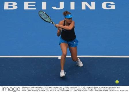 (151005) -- BEIJING, Oct. 5, 2015 -- Belinda Bencic of Switzerland returns the shot during the women s singles first round match of China Open Tennis Tournament against Madison Brengle of the United States at National Tennis Center in Beijing, capital of China on Oct. 5, 2015. Bencic won 2-1. ) (SP)CHINA-BEIJING-TENNIS-CHINA OPEN-WOMEN S SINGLES-1ST ROUND(CN) XingxGuangli 