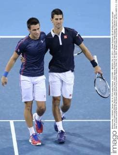 (151008) -- BEIJING, Oct. 8, 2015 -- Novak Djokovic (R) of Serbia and his younger brother and teammate Djordje Djokovic react during their match against Jack Sock of the United States and Vasek Pospisil of Canada at the men s doubles quarterfinal of the China Open tennis tournament in Beijing, China, Oct. 8, 2015. Novak Djokovic and Djordje Djokovic lost the match 0-2. ) (SP)CHINA-BEIJING-TENNIS-CHINA OPEN-MEN S DOUBLES-QUARTER FINAL XingxGuangli 