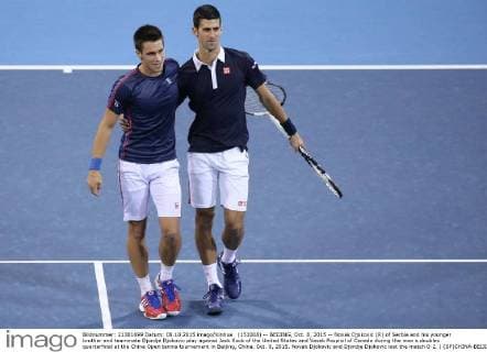 (151008) -- BEIJING, Oct. 8, 2015 -- Novak Djokovic (R) of Serbia and his younger brother and teammate Djordje Djokovic play against Jack Sock of the United States and Vasek Pospisil of Canada during the men s doubles quarterfinal at the China Open tennis tournament in Beijing, China, Oct. 8, 2015. Novak Djokovic and Djordje Djokovic lost the match 0-2. ) (SP)CHINA-BEIJING-TENNIS-CHINA OPEN-MEN S DOUBLES-QUARTER FINAL XingxGuangli 