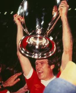 Football - 1977 European Cup Final - Liverpool 3 Borussia Monchengladbach 1 Liverpool captain Emlyn Hughes lifts the European Cup trophy at the Stadio Olimpico, Rome. 25 05 1977 