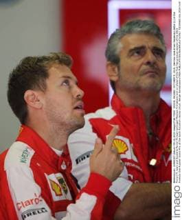 SOCHI, RUSSIA. OCTOBER 9, 2015. German race driver Sebastian Vettel (L) of the Ferrari F1 team and Scuderia Ferrari F1 team principal Maurizio Arrivabene look on ahead of the first free practice session of the 2015 Formula One Russian Grand Prix at the Sochi Autodrom racing circuit. Sergei Savostyanov TASS  TS00F6E0