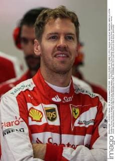 SOCHI, RUSSIA. OCTOBER 9, 2015. German race driver Sebastian Vettel (L) of the Scuderia Ferrari looks on ahead of the first free practice session of the 2015 Formula One Russian Grand Prix at the Sochi Autodrom racing circuit. Sergei Savostyanov TASS  TS00F6EE