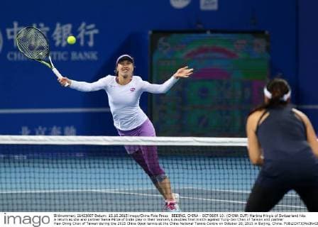 BEIJING, CHINA - OCTOBER 10: (CHINA OUT) Martina Hingis of Switzerland hits a return as she and partner Sania Mirza of India play in their women s doubles final match against Yung-Jan Chan of Taiwan and partner Hao-Ching Chan of Taiwan during the 2015 China Open tennis at the China National Tennis Centre on October 10, 2015 in Beijing, China.  CFP474184491 
