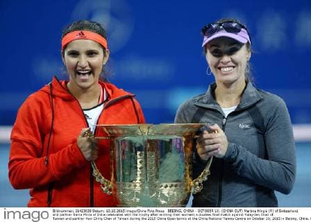 BEIJING, CHINA - OCTOBER 10: (CHINA OUT) Martina Hingis (R) of Switzerland and partner Sania Mirza of India celebrates with the trophy after winning their women s doubles final match against Yung-Jan Chan of Taiwan and partner Hao-Ching Chan of Taiwan during the 2015 China Open tennis at the China National Tennis Centre on October 10, 2015 in Beijing, China.  CFP474184497 
