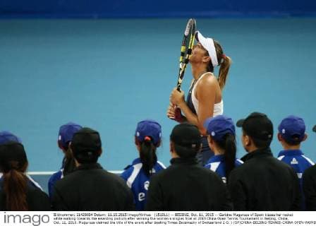 (151011) -- BEIJING, Oct. 11, 2015 -- Garbine Muguruza of Spain kisses her racket while walking towards the awarding podium after winning the women s singles final at 2015 China Open Tennis Tournament in Beijing, China, Oct. 11, 2015. Muguruza claimed the title of the event after beating Timea Bacsinszky of Switzerland 2-0. ) (SP)CHINA-BEIJING-TENNIS-CHINA OPEN-WOMEN S SINGLES-FINAL XingxGuangli 