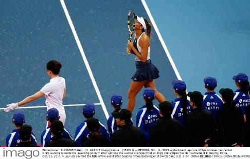 (151011) -- BEIJING, Oct. 11, 2015 -- Garbine Muguruza of Spain kisses her racket while walking towards the awarding podium after winning the women s singles final at 2015 China Open Tennis Tournament in Beijing, China, Oct. 11, 2015. Muguruza claimed the title of the event after beating Timea Bacsinszky of Switzerland 2-0. ) (SP)CHINA-BEIJING-TENNIS-CHINA OPEN-WOMEN S SINGLES-FINAL WangxLili 