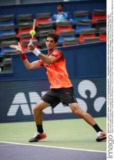 Thomaz Bellucci of Brazil returns a shot to Milos Raonic of Canada in their first round match of the men s singles during the 2015 Shanghai Rolex Masters tennis tournament in Shanghai, China, 13 October 2015. Milos Raonic of Canada defeated Thomaz Bellucci of Brazil 2-0 (7-6 7-6) in their first round match of the men s singles during the 2015 Shanghai Rolex Masters tennis tournament in Shanghai, China, 13 October 2015. Milos Raonic ousts Thomaz Bellucci at Shanghai Rolex Masters  20151013_32185