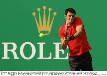 Bernard Tomic of Australia returns a shot to David Ferrer of Spain in their second round match of the men s singles during the 2015 Shanghai Rolex Masters tennis tournament in Shanghai, China, 14 October 2015. Bernard Tomic of Australia defeated David Ferrer of Spain 2-0 (6-4 6-2) in their second round match of the men s singles during the 2015 Shanghai Rolex Masters tennis tournament in Shanghai, China, 14 October 2015. David Ferrer kicked out by Bernard Tomic at Shanghai Rolex Masters  pbu344940_01
