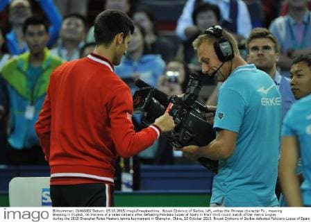 Novak Djokovic of Serbia, left, writes the Chinese character Fu , meaning Blessing in English, on the lens of a video camera after defeating Feliciano Lopez of Spain in their third round match of the men s singles during the 2015 Shanghai Rolex Masters tennis tournament in Shanghai, China, 15 October 2015. Novak Djokovic of Serbia defeated Feliciano Lopez of Spain 2-0 (6-2 6-3) in their third round match of the men s singles during the 2015 Shanghai Rolex Masters tennis tournament in Shanghai, China, 15 October 2015. Novak Djokovic conquers Feliciano Lopez at Shanghai Rolex Masters  pbu345717_04