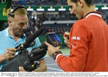 Novak Djokovic of Serbia, right, writes the Chinese character Fu , meaning Blessing in English, on the lens of a video camera after defeating Feliciano Lopez of Spain in their third round match of the men s singles during the 2015 Shanghai Rolex Masters tennis tournament in Shanghai, China, 15 October 2015. Novak Djokovic of Serbia defeated Feliciano Lopez of Spain 2-0 (6-2 6-3) in their third round match of the men s singles during the 2015 Shanghai Rolex Masters tennis tournament in Shanghai, China, 15 October 2015. Novak Djokovic conquers Feliciano Lopez at Shanghai Rolex Masters  20151015_33964