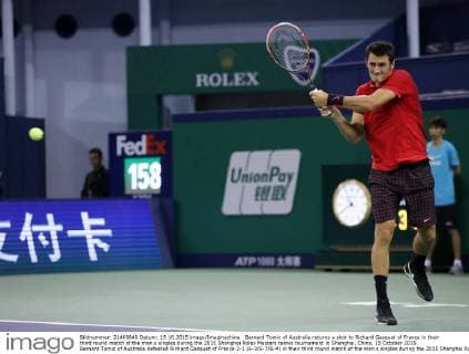 Bernard Tomic of Australia returns a shot to Richard Gasquet of France in their third round match of the men s singles during the 2015 Shanghai Rolex Masters tennis tournament in Shanghai, China, 15 October 2015. Bernard Tomic of Australia defeated Richard Gasquet of France 2-1 (6-3 6-7 6-4) in their third round match of the men s singles during the 2015 Shanghai Rolex Masters tennis tournament in Shanghai, China, 15 October 2015. Bernard Tomic defeats Richard Gasquet at Shanghai Rolex Masters  20151015_36640