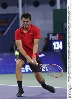 Bernard Tomic of Australia returns a shot to Richard Gasquet of France in their third round match of the men s singles during the 2015 Shanghai Rolex Masters tennis tournament in Shanghai, China, 15 October 2015. Bernard Tomic of Australia defeated Richard Gasquet of France 2-1 (6-3 6-7 6-4) in their third round match of the men s singles during the 2015 Shanghai Rolex Masters tennis tournament in Shanghai, China, 15 October 2015. Bernard Tomic defeats Richard Gasquet at Shanghai Rolex Masters  20151015_67583