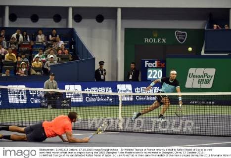 Jo-Wilfried Tsonga of France returns a shot to Rafael Nadal of Spain in their semi-final match of the men s singles during the 2015 Shanghai Rolex Masters tennis tournament in Shanghai, China, 17 October 2015. Jo-Wilfried Tsonga of France defeated Rafael Nadal of Spain 2-1 (6-4 0-6 7-5) in their semi-final match of the men s singles during the 2015 Shanghai Rolex Masters tennis tournament in Shanghai, China, 17 October 2015. Jo-Wilfried Tsonga ousts Rafael Nadal to advance to final at Shanghai Rolex Masters  20151017_09772