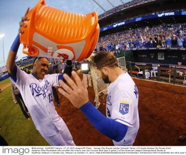 Kansas City Royals catcher Salvador Perez (13) dunks Kansas City Royals third baseman Mike Moustakas with ice after the victory over the Toronto Blue Jays in game 2 of the American League Championship Series at Kauffman Stadium in Kansas City, Missouri on October 17, 2015.  KCP20151017243 KYLExRIVAS