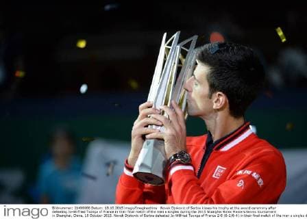 Novak Djokovic of Serbia kisses his trophy at the award ceremony after defeating Jo-Wilfried Tsonga of France in their final match of the men s singles during the 2015 Shanghai Rolex Masters tennis tournament in Shanghai, China, 18 October 2015. Novak Djokovic of Serbia defeated Jo-Wilfried Tsonga of France 2-0 (6-2 6-4) in their final match of the men s singles during the 2015 Shanghai Rolex Masters tennis tournament in Shanghai, China, 18 October 2015. Djokovic defeats Jo-Wilfried Tsonga to win Shanghai Masters final  20151018_50437