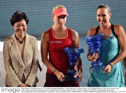 Jelena Jankovic of Serbia, right, and Angelique Kerber of Germany, center, hold their trophies of champion and runner-up respectively at the award ceremony after their final match of the women s singles during the 2015 Hong Kong Open tennis tournament in Hong Kong, China, 18 October 2015. Jelena Jankovic of Serbia defeated Angelique Kerber of Germany 2-1 (3-6 7-6 6-1) in their final match of the women s singles during the 2015 Hong Kong Open tennis tournament in Hong Kong, China, 18 October 2015. Jelena Jankovic crowns Hong Kong Open title  20151019_25089