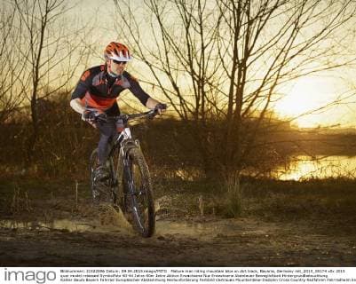 Mature man riding mountain bike on dirt track, Bavaria, Germany mit_2013_00174
