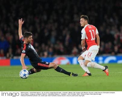Arsenal s Mesut Ozil tussles with Bayern Munich s Xabi Alonso Champions League Group Match - Arsenal vs Bayern Munich - Emirates Stadium - England - 20th October 2015 - Picture David Klein Sportimage EDITORIAL USE ONLY. No use with unauthorised audio, video, data, fixture lists, club league logos or live services. Online in-match use limited to 120 images, no video emulation. No use in betting, games or single club league player publications.