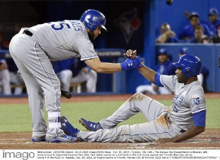 Oct. 20, 2015 - Toronto, ON, CAN - The Kansas City Royals Kendrys Morales, left, lends a hand to teammate Lorenzo Cain after Cain safely scored on a wild pitch in the first inning against the Toronto Blue Jays during Game 4 of the ALCS on Tuesday, Oct. 20, 2015, at Rogers Centre in Toronto. Kansas City at Toronto, ALCS Game 4 - ZUMAm67_