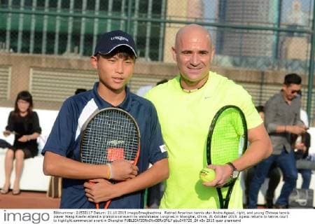 Retired American tennis star Andre Agassi, right, and young Chinese tennis player Wang Xiaofei attend a promotional event by watchmaker Longines in Shanghai, China, 21 October 2015. Agassi returns to tennis court to highlight commercial event in Shanghai  pbu348725_24