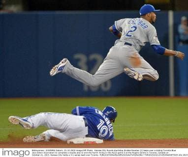 Kansas City Royals shortstop Alcides Escobar (2) leaps over a sliding Toronto Blue Jays Edwin Incarnation to complete a double play to end the fourth inning in the ALCS game 5 at the Rogers Centre in Toronto, Canada on October 21, 2015. Kansas City holds a 3-1 series lead over Toronto.  TOR2015102115 KEVINxDIETSCH