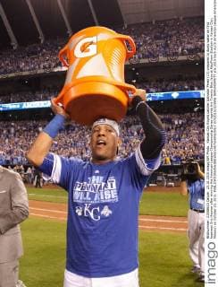 Kansas City Royals catcher Salvador Perez (13) prepares to dump water on first baseman Eric Hosmer after winning the American League Championship Series against the Toronto Blue Jays at Kauffman Stadium in Kansas City, Missouri on October 23, 2015.  KCP20151023506 JEFFxMOFFETT