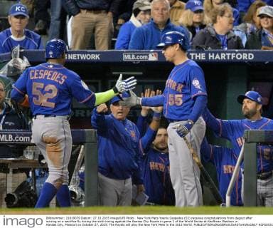 New York Mets Yoenis Cespedes (52) receives congratulations from dugout after scoring on a sacrifice fly during the sixth inning against the Kansas City Royals in game 1 of the World Series at Kauffman Stadium in Kansas City, Missouri on October 27, 2015. The Royals will play the New York Mets in the 2015 World.  KCP2015102726 KEVINxDIETSCH