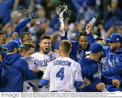 Kansas City Royals swarm around first baseman Eric Hosmer after his game-winning sacrifice fly in the 14th inning beat the New York Mets in game 1 of the World Series at Kauffman Stadium in Kansas City, Missouri on October 27, 2015. Kansas City beats New York 5-4 in 14 innings to take a 1-0 series lead.  KCP2015102765 KEVINxDIETSCH