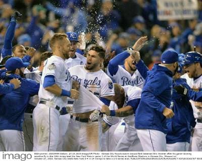 Kansas City Royals swarm around first baseman Eric Hosmer after his game-winning sacrifice fly in the 14th inning beat the New York Mets in game 1 of the World Series at Kauffman Stadium in Kansas City, Missouri on October 27, 2015. Kansas City beats New York 5-4 in 14 innings to take a 1-0 series lead.  KCP2015102767 KEVINxDIETSCH
