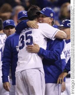Kansas City Royals manager Ned Yost (R) hugs Eric Hosmer (35) after his sacrifice fly scored Alcides Escobar in the 14th inning against the New York Mets inf game 1 of the World Series at Kauffman Stadium in Kansas City, Missouri on October 27, 2015. The Royals defeated the Mets 5-4.  KCP20151027238 JEFFxMOFFETT