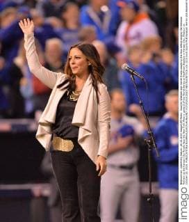 Country Western star Sarah Evans waves to the fans before singing the National Anthem as the Kansas City Royals face the New York Mets in game 2 of the World Series at Kauffman Stadium in Kansas City, Missouri on October 28, 2015.  KCP20151028207 KEVINxDIETSCH