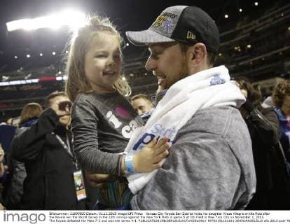 Kansas City Royals Ben Zobrist holds his daughter Kruse Allegra on the field after the Royals win the World Series in the 12th innings against the New York Mets in game 5 at Citi Field in New York City on November 1, 2015. The Royals defeated the Mets 7-2 and won the series 4-1.  NYP20151101181 JOHNxANGELILLO