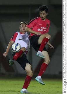 DUBAI, UNITED ARAB EMIRATES - NOVEMBER 04: (CHINA OUT) Huang Wenbo (L) and Liu Jian of Guangzhou Evergrande in action during the training session ahead of the final match between Al Ahli and Guangzhou Evergrande as part of 2015 AFC Champions League on November 4, 2015 in Dubai, United Arab Emirates.  CFP475416878 