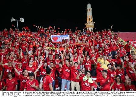 DUBAI, UNITED ARAB EMIRATES - NOVEMBER 07: (CHINA OUT) Guangzhou Evergrande fans cheer prior to the first leg of the AFC Champions League final match between Al Ahli and Guangzhou Evergrande at the Al-Rashid Stadium on November 7, 2015 in Dubai, United Arab Emirates.  CFP475532095 