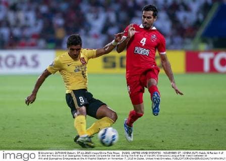 DUBAI, UNITED ARAB EMIRATES - NOVEMBER 07: (CHINA OUT) Habib Al Fardan 4 of Al Ahli and Paulinho 8 of Guangzhou Evergrande compete for the ball during the first leg of the AFC Champions League final match between Al Ahli and Guangzhou Evergrande at the Al-Rashid Stadium on November 7, 2015 in Dubai, United Arab Emirates.  CFP475532583 