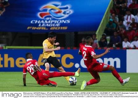 DUBAI, UNITED ARAB EMIRATES - NOVEMBER 07: (CHINA OUT) Abdulaziz Hussain 26 of Al Ahli and Li Xuepeng 35 of Guangzhou Evergrande compete for the ball during the first leg of the AFC Champions League final match between Al Ahli and Guangzhou Evergrande at the Al-Rashid Stadium on November 7, 2015 in Dubai, United Arab Emirates.  CFP475533633 