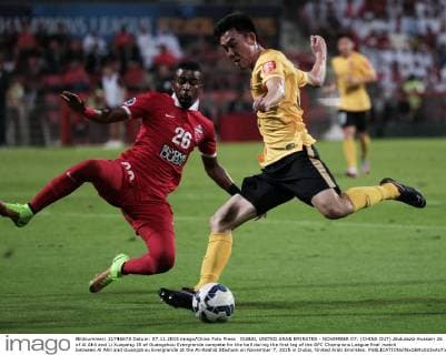 DUBAI, UNITED ARAB EMIRATES - NOVEMBER 07: (CHINA OUT) Abdulaziz Hussain 26 of Al Ahli and Li Xuepeng 35 of Guangzhou Evergrande compete for the ball during the first leg of the AFC Champions League final match between Al Ahli and Guangzhou Evergrande at the Al-Rashid Stadium on November 7, 2015 in Dubai, United Arab Emirates.  CFP475533636 