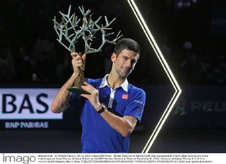 Novak Djokovic of Serbia holds the championship trophy after winning his finals match against Andy Murray of Great Britain at the BNP Paribas Masters in Paris on November 8, 2015. Djokovic defeated Murray 6-2, 6-4 to win his fourth Masters title in Paris.  PAR20151108702 DAVIDxSILPA