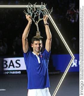 Novak Djokovic of Serbia holds the championship trophy after winning his finals match against Andy Murray of Great Britain at the BNP Paribas Masters in Paris on November 8, 2015. Djokovic defeated Murray 6-2, 6-4 to win his fourth Masters title in Paris.  PAR20151108704 DAVIDxSILPA