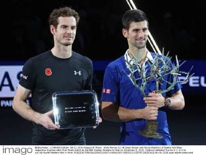 Andy Murray (L) of Great Britain and Novak Djokovic of Serbia hold their respective trophies after their finals match at the BNP Paribas Masters in Paris on November 8, 2015. Djokovic defeated Murray 6-2, 6-4 to win his fourth Masters title in Paris.  PAR20151108740 DAVIDxSILPA