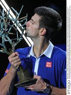 Novak Djokovic of Serbia kisses the championship trophy after winning his finals match against Andy Murray of Great Britain at the BNP Paribas Masters in Paris on November 8, 2015. Djokovic defeated Murray 6-2, 6-4 to win his fourth Masters title in Paris.  PAR20151108741 DAVIDxSILPA