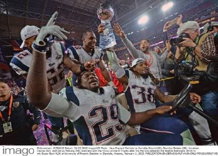New England Patriots Le Garrette Blount (29), Brandon Bolden (38), Jonathan Casilas (52), and Darius Fleming (58) celebrate with the Vince Lombardi Trophy after the Patriots defeated the Seattle Seahawks 28-24 to win Super Bowl XLIX at University of Phoenix Stadium in Glendale, Arizona, February 1, 2015.  POY2015S017 KEVINxDIETSCH